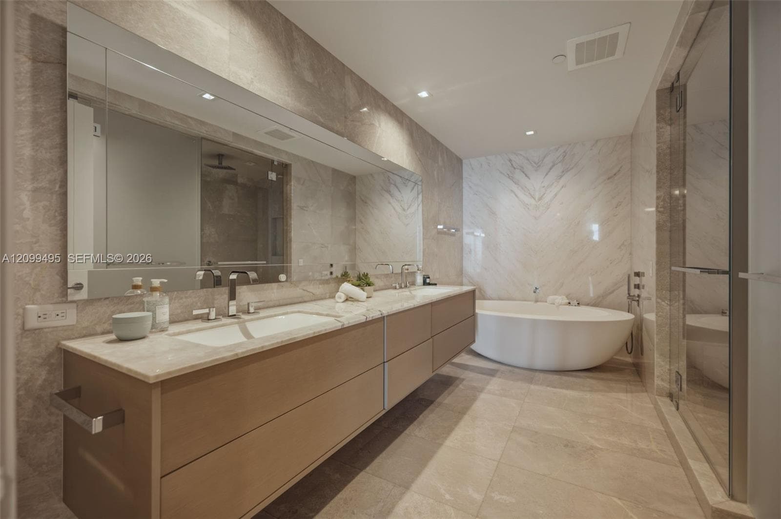 Master Bathroom features a book-matched marble wall, marble flooring along with European Dornbracht® fixtures.