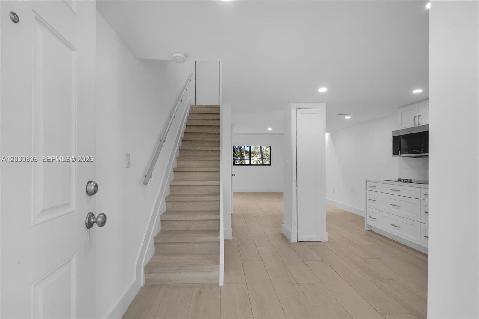 Look how open and non-claustrophobic this floor-plan is & notice the new kitchen cabinets & Appliances are on the right side and the beautiful tile floors enhance and appear to look like wood that are through-out the whole unit except the bathrooms.