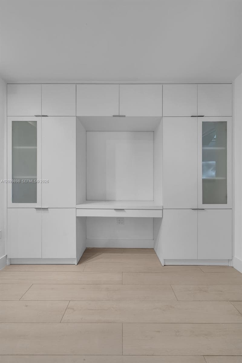 Look how nice the glass doors look on either side of the built-in computer desk/entertainment center and how much hidden storage one has in this built-in cabinet!