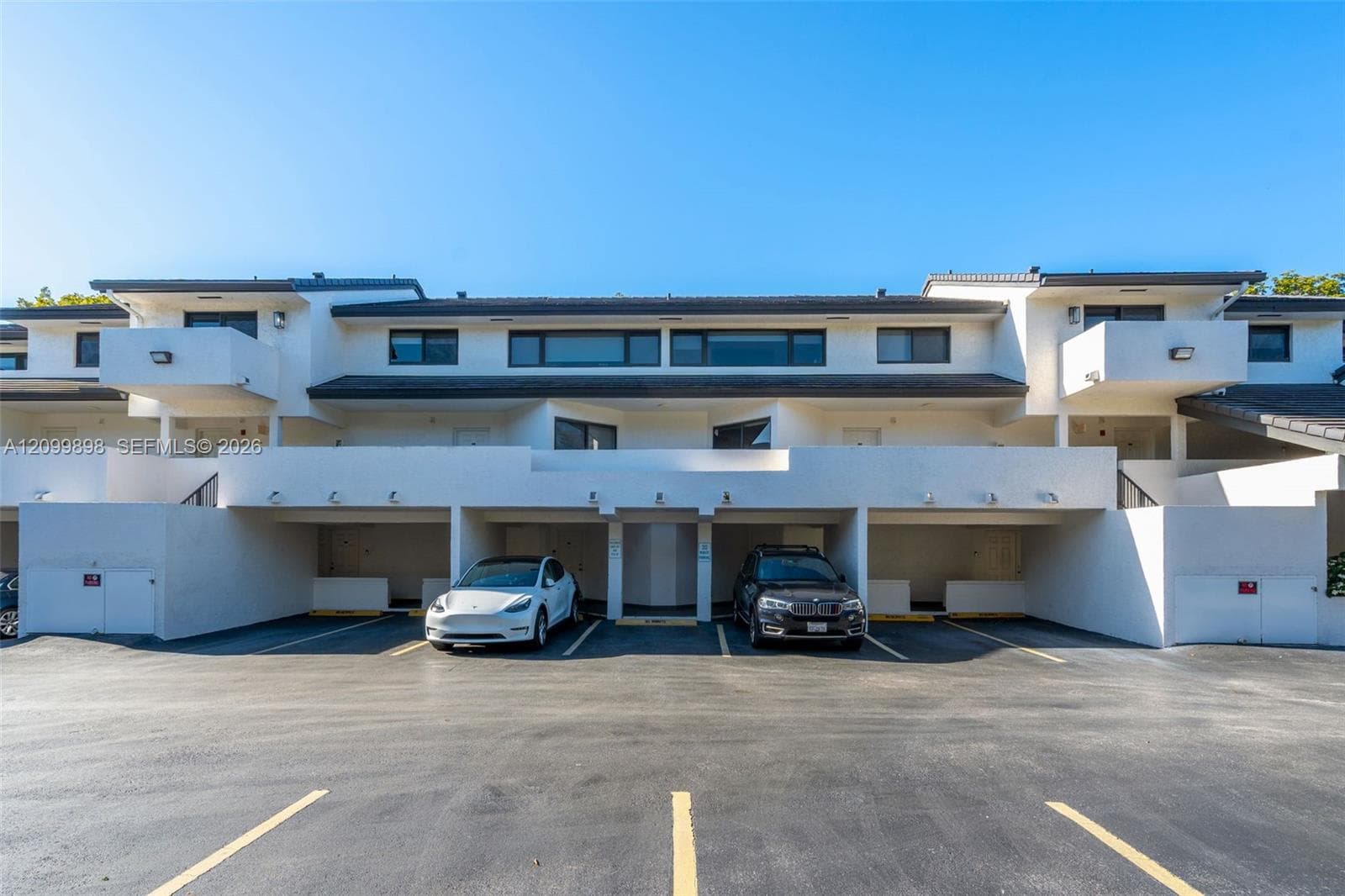 Parking space is #20 & is between the white Tesla and the dark blue BMW! The "Primary Bedroom" has the large  balcony to the left of the white Tesla and only 1 other unit in the building has the extended balcony that looks out to the South East skyline at treetop heights overlooking a quiet residential neighborhood!
