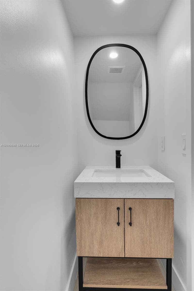 The "Half-Bath is by the Family-room and has a new vanity & mirror & LED lite!.