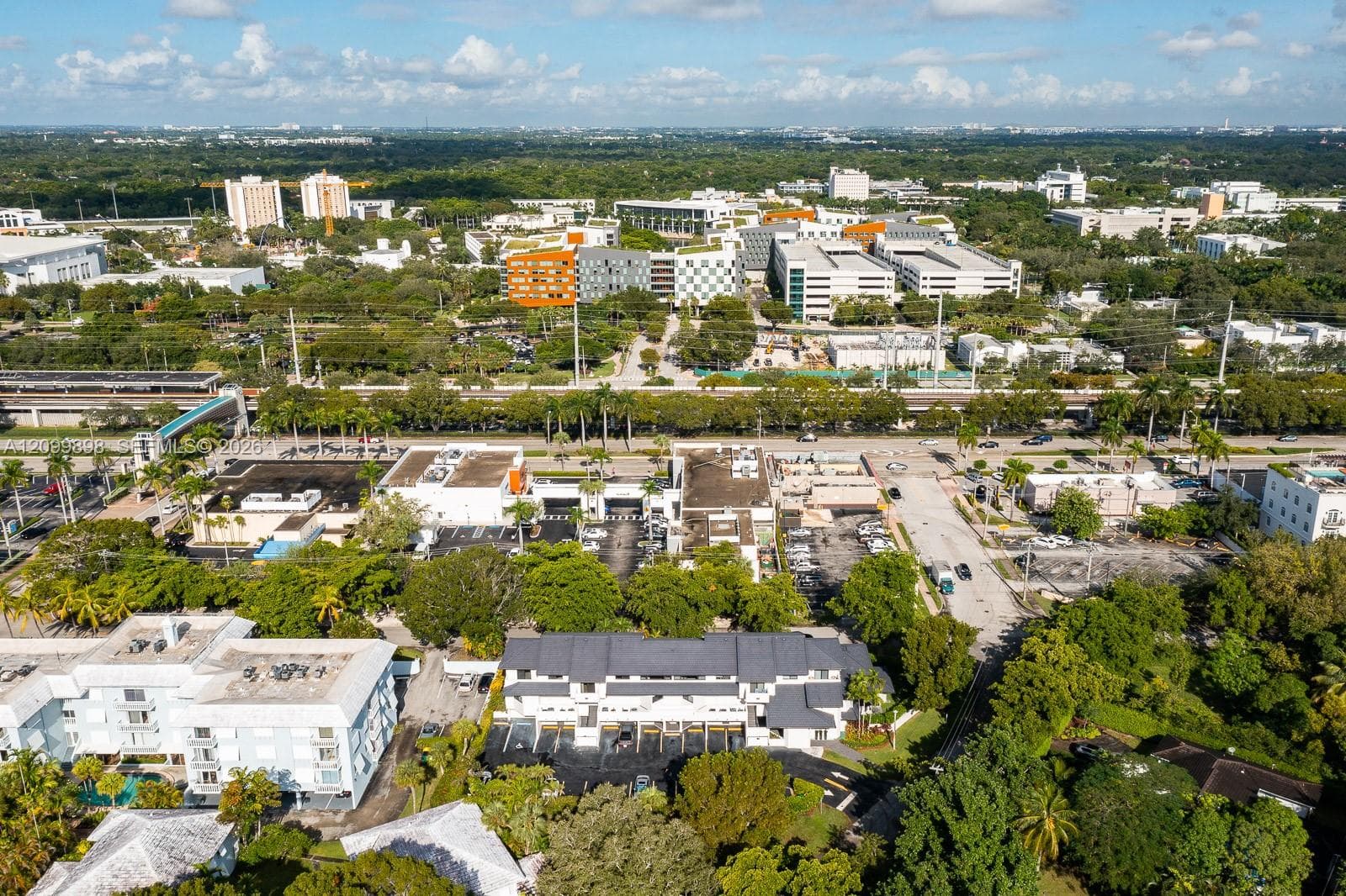 In this picture, if you look a little to the left and you will see the "Pedestrian Cross Over Bridge" ( SEE THE AQUA BLUE ROOF ) taking everyone safely over the major Highway! At the end of the "Pedestrian Cross Over Bridge is the University Metro-Rail Station and of course beyond that is the whole University of Miami's main campus!