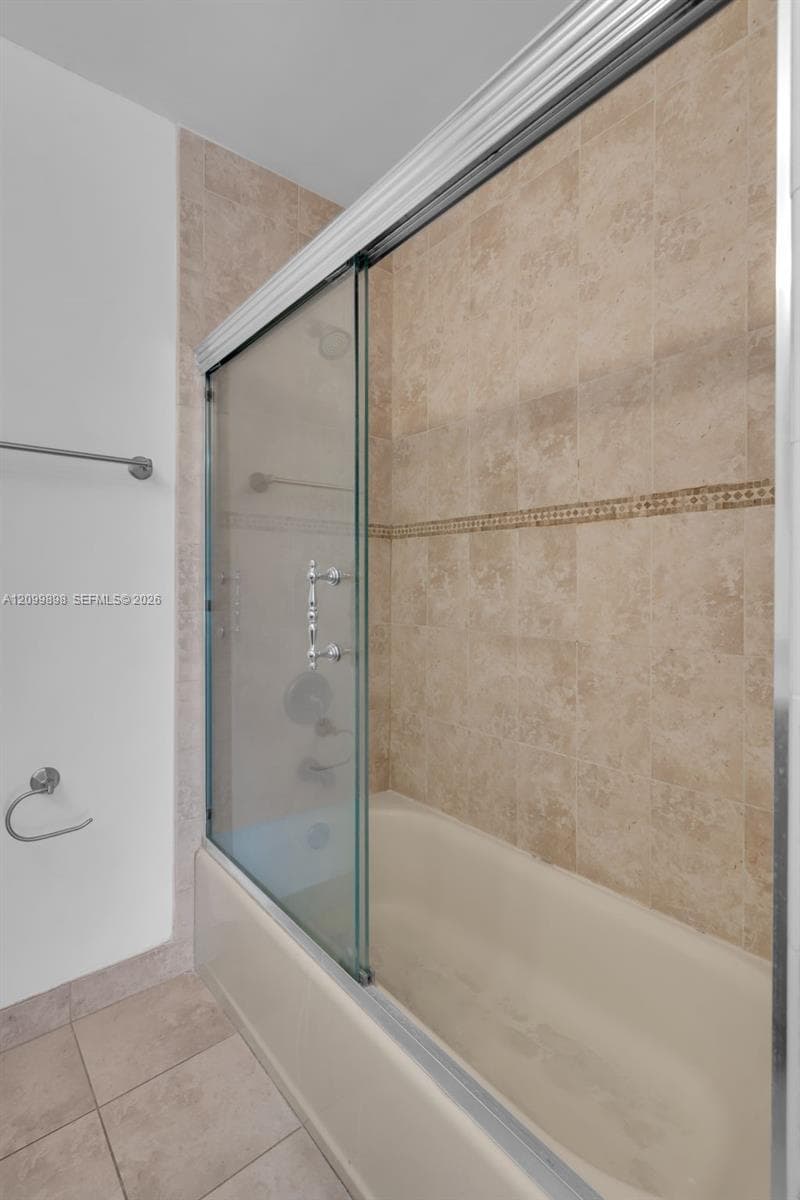 The 2nd Bedroom en-suite Bathroom has a nice tub and nice glass doors.