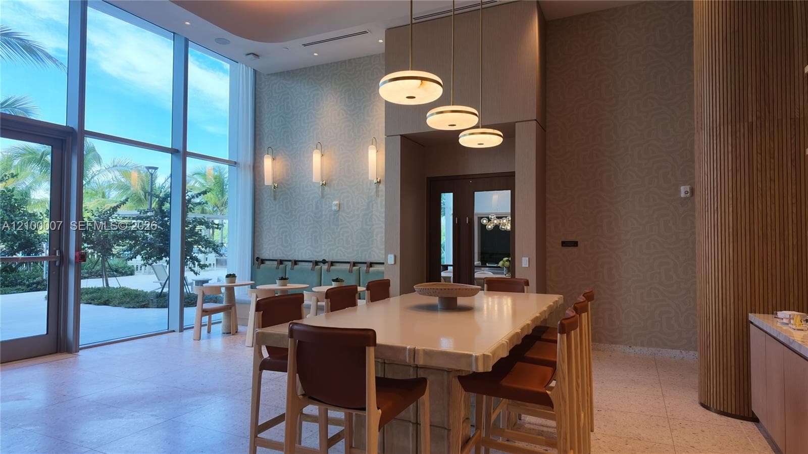 Expansive floor-to-ceiling windows, patterned accent wall, recessed lighting, modern pendant lighting, and wood-slat wall paneling