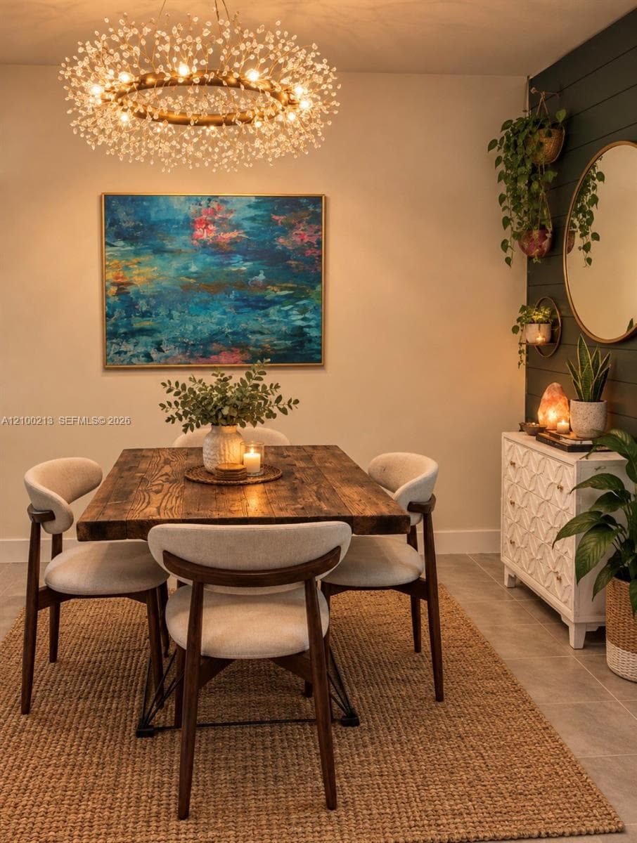 Circular starburst chandelier, dark-stained shiplap accent wall, and large-format tile flooring