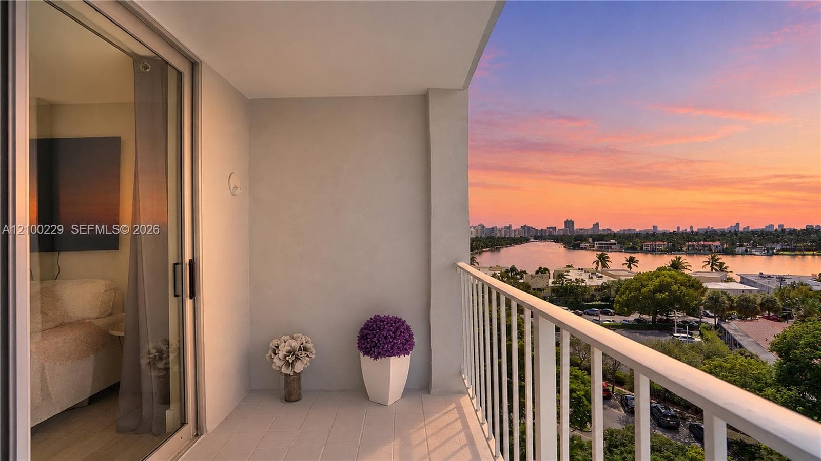 Covered balcony featuring a metal railing, neutral floor surfacing, and sliding glass entry