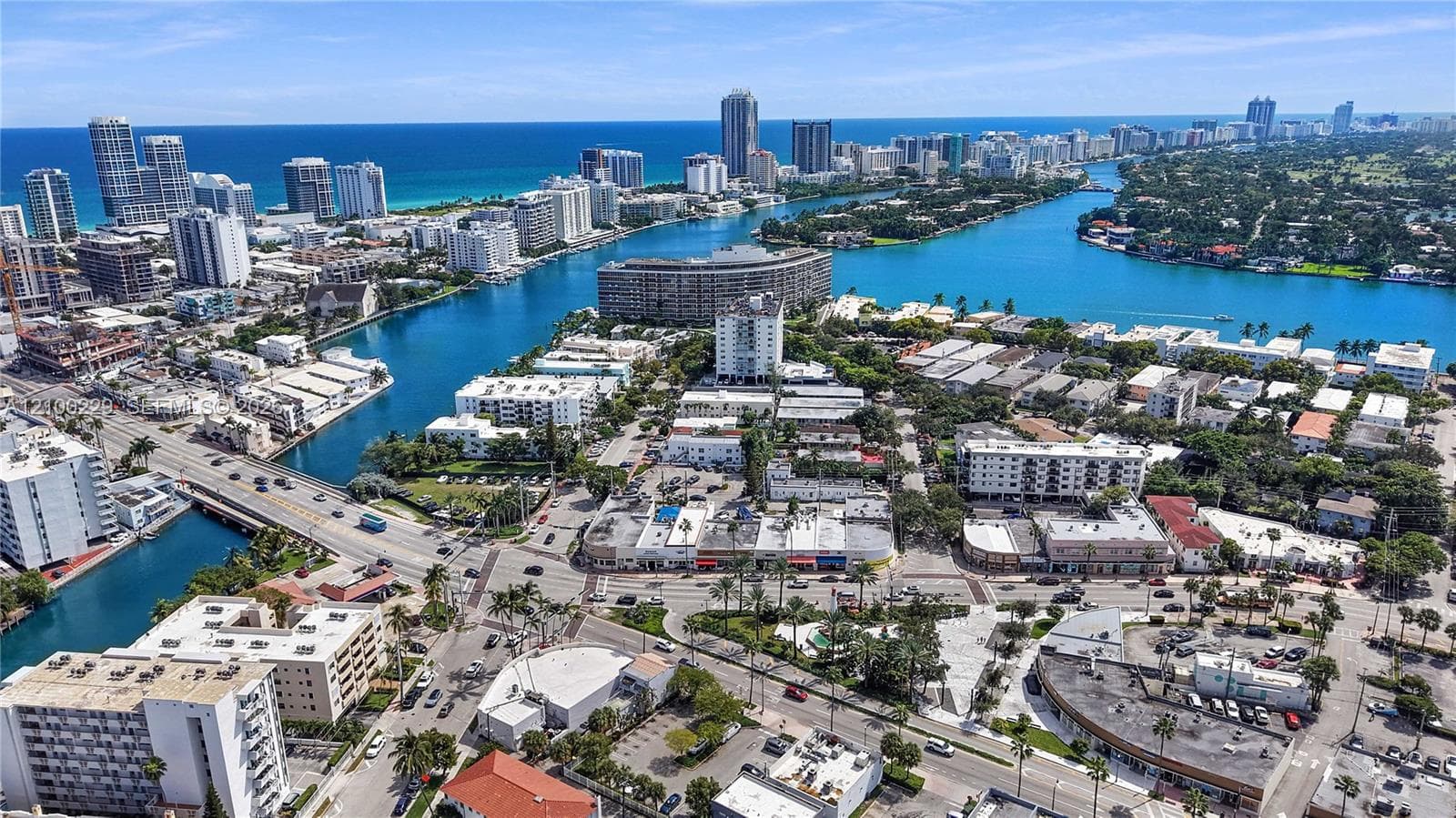 Aerial perspective of coastal urban environment featuring waterway access, mid-rise developments, high-density infrastructure, and proximity to the oceanfront