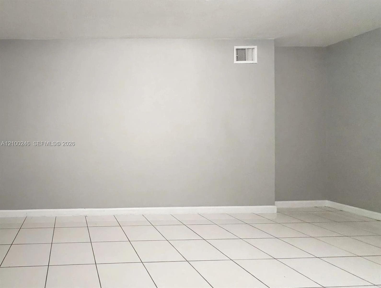 Neutral-toned walls paired with large-format tile flooring