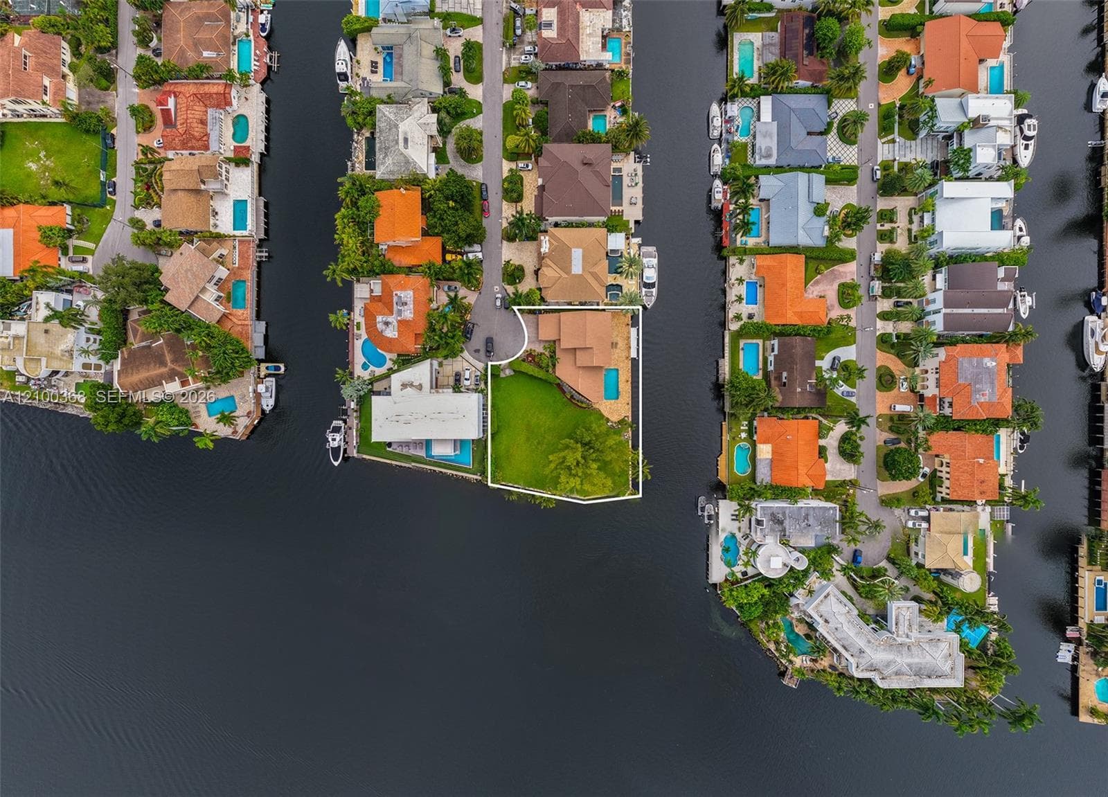 Waterfront property featuring a private swimming pool, expansive corner lot, and bulkhead perimeter
