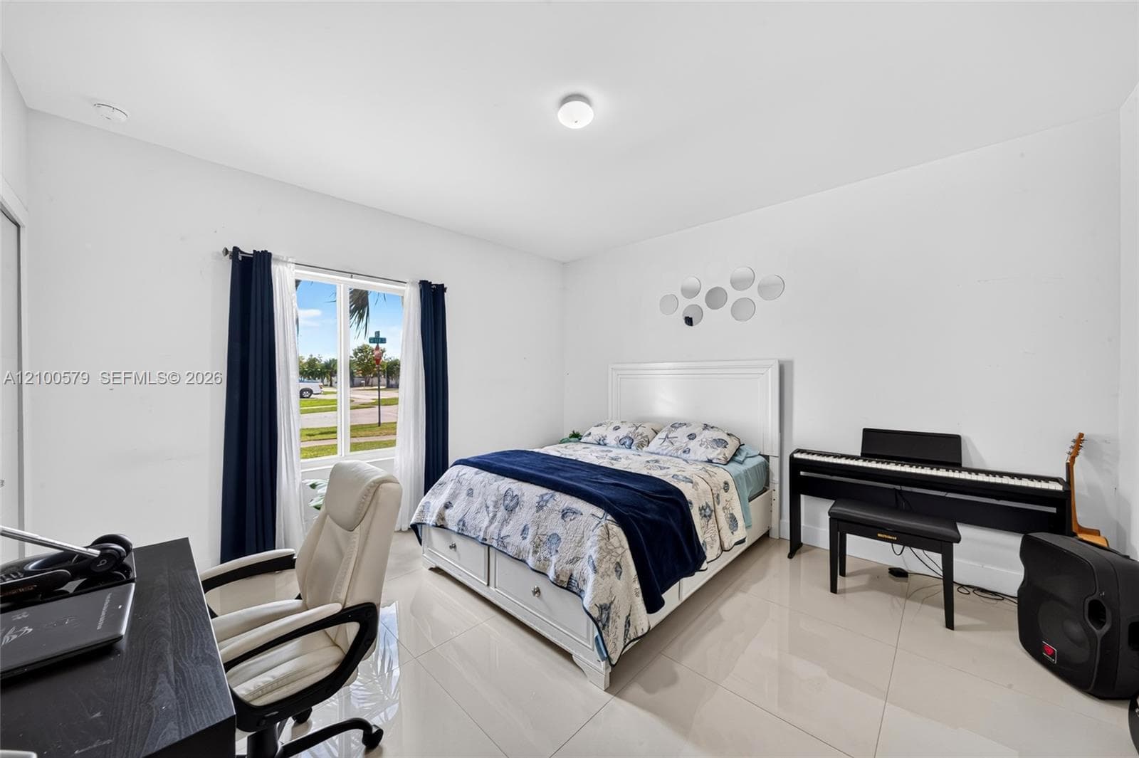 Room featuring large-format tile flooring, high-gloss white walls, and a recessed ceiling light fixture