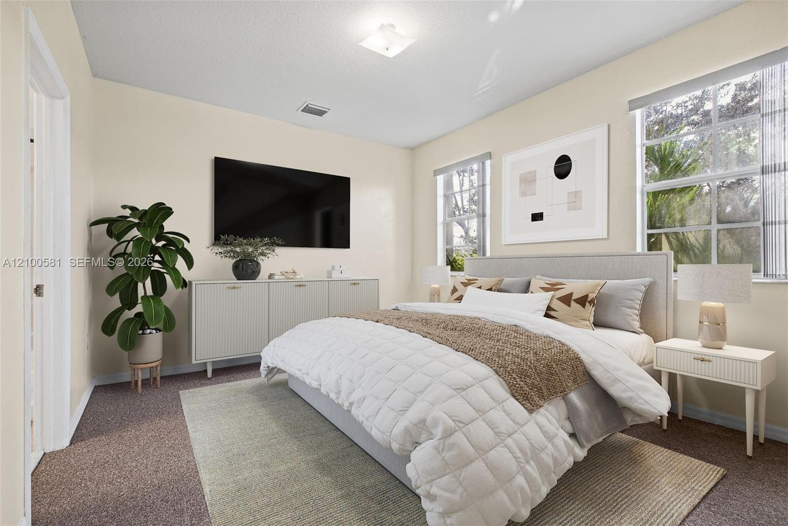 Neutral-toned bedroom featuring carpeted flooring, large window, and paneled interior doors