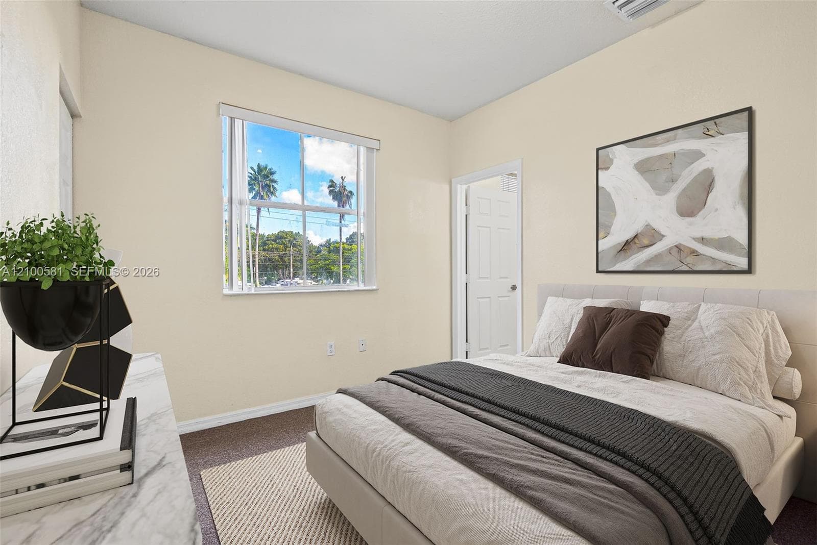 Neutral interior room featuring plush carpeting, a single-panel interior door, and a multi-panel closet door