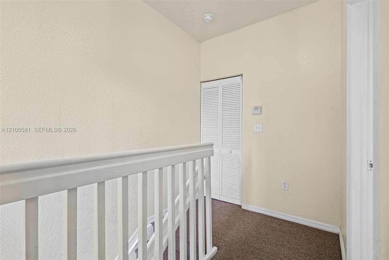 Neutral wall tones, carpeting, and white interior doors with satin nickel hardware