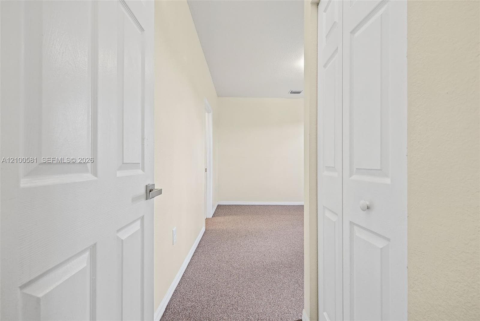 Bedroom featuring neutral wall paint, plush carpeting, dual windows, and a flush-mount ceiling light fixture