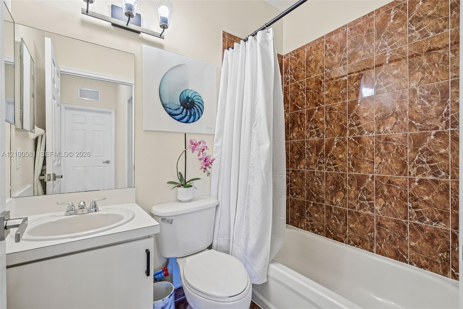 Laundry area featuring tile flooring, white panel doors, and a wall-mounted wire storage shelf