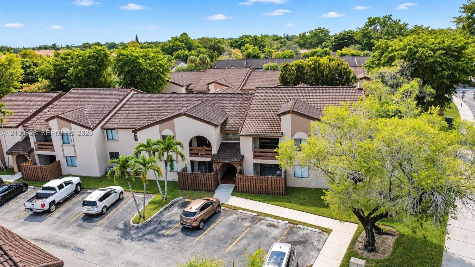Multi-unit residential complex featuring stucco exterior, tiled roof and  parking