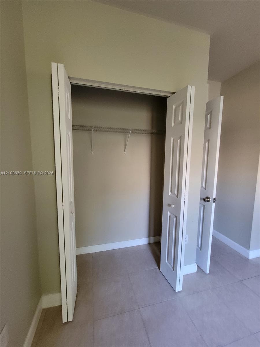 Closet featuring white six-panel bi-fold doors and interior wire shelving