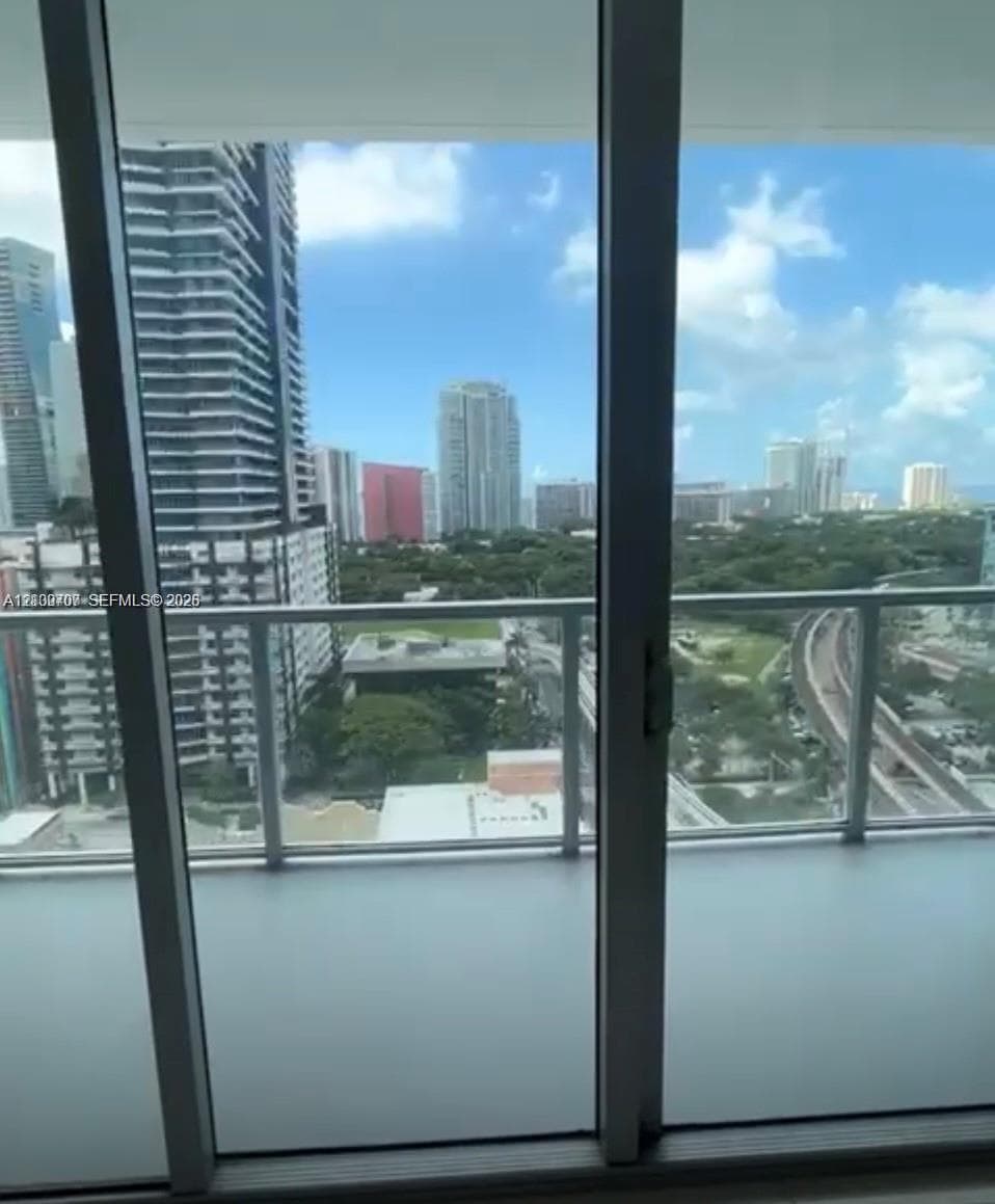 Private balcony featuring floor-to-ceiling glass sliding doors and a metal railing