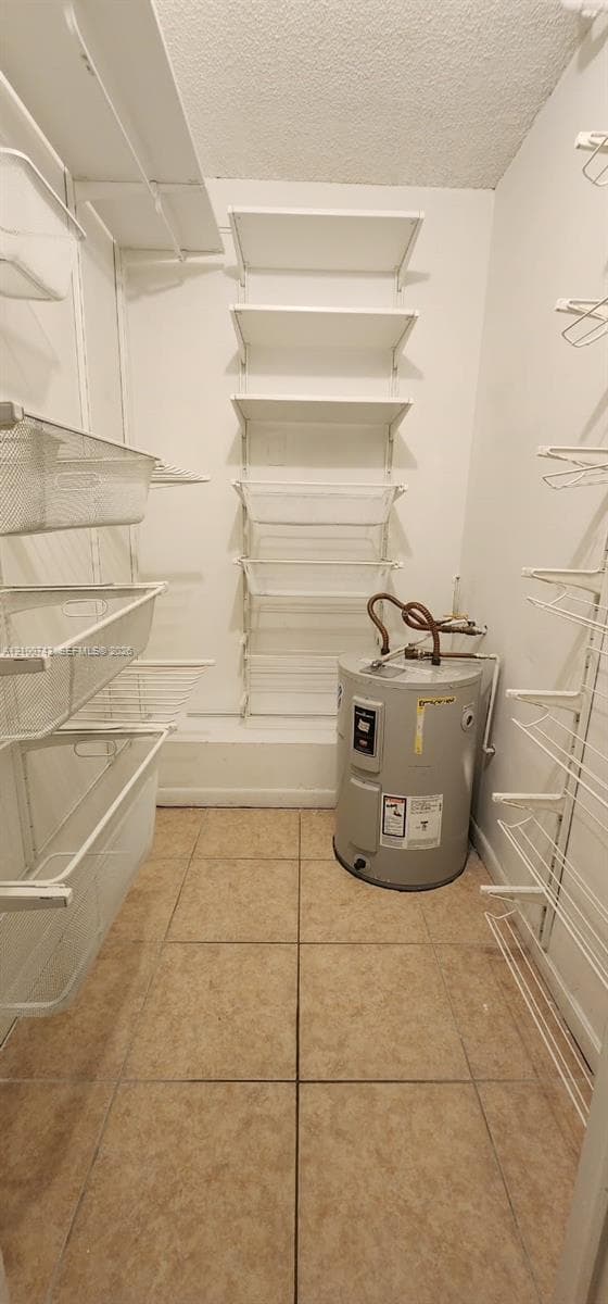 Storage area featuring ceramic tile flooring and white wire shelving units