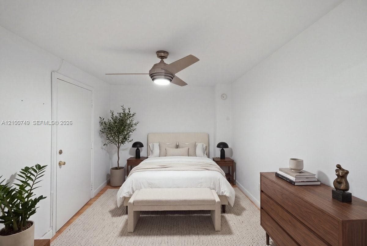 Neutral-toned tile flooring, multi-blade brushed metal ceiling fan with integrated lighting, and window with pleated vertical blinds