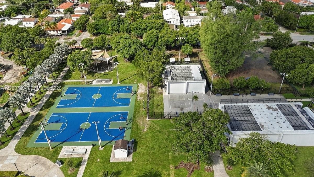 Aerial perspective of municipal park facilities featuring baseball diamonds, multi-purpose synthetic turf fields, tennis courts, and pedestrian pathways