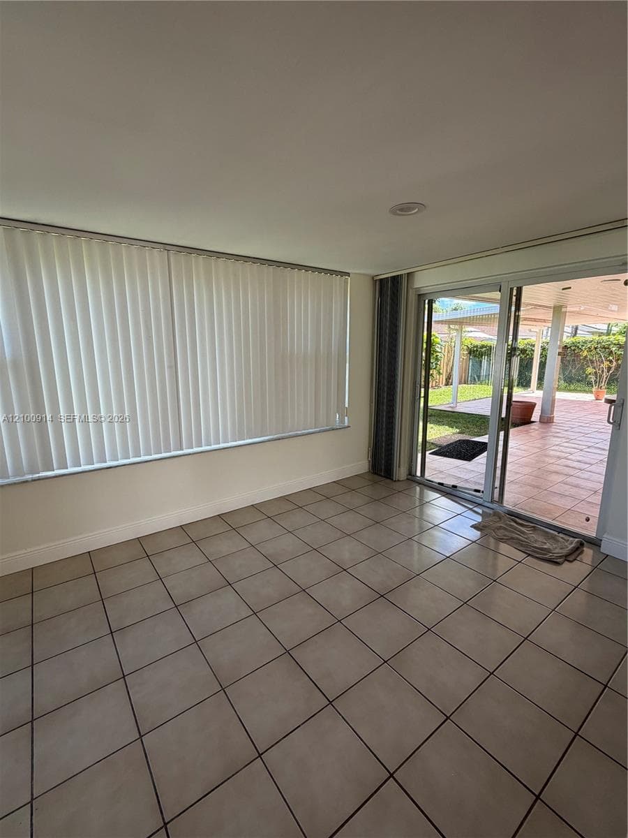 Tile flooring, recessed lighting, and expansive wall-to-wall windows
