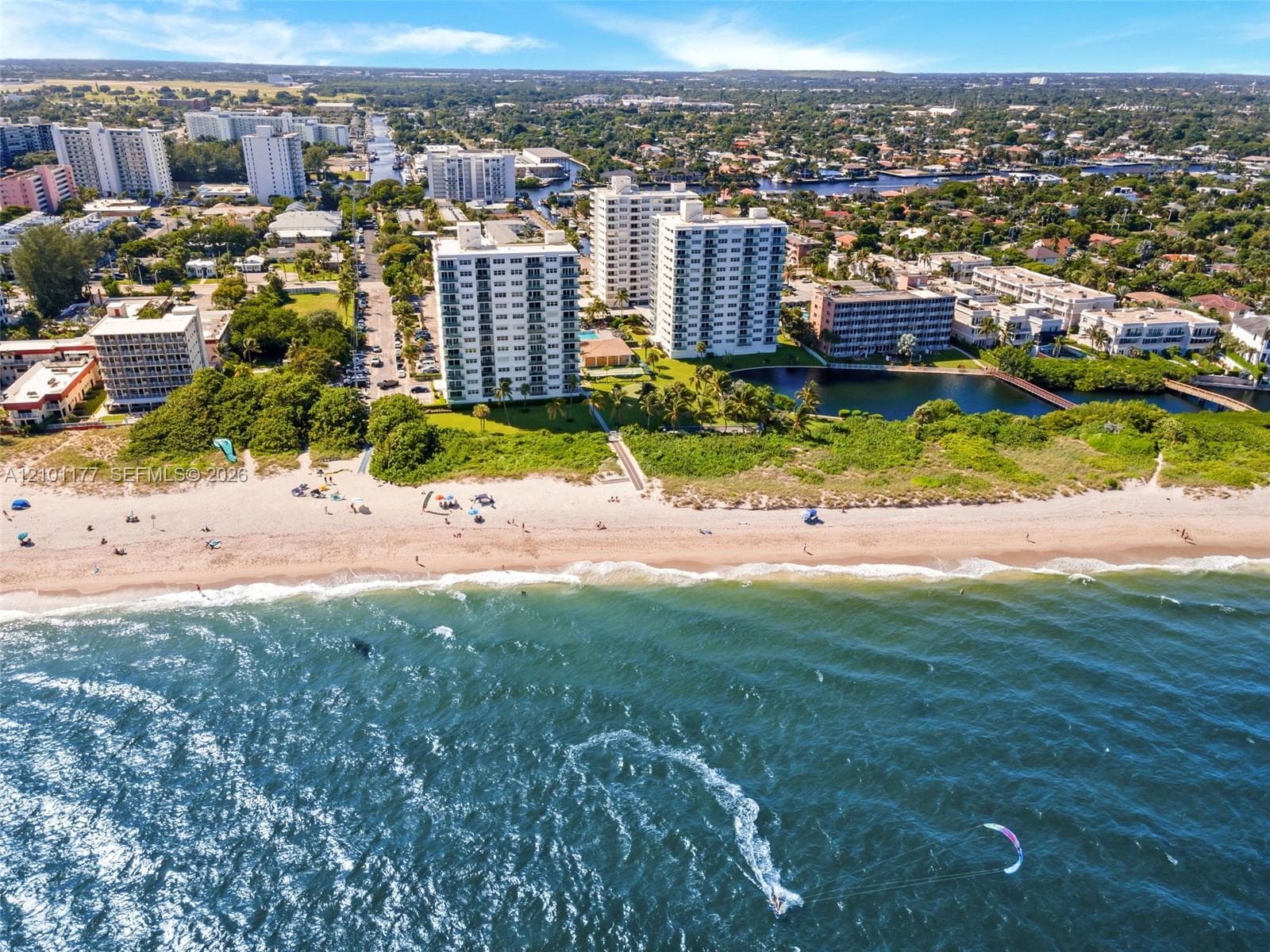 High-rise condominium buildings situated on a beachfront parcel featuring direct access to the ocean, coastal shoreline, and surrounding waterways