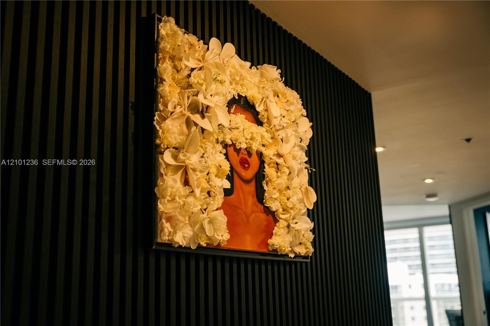 Textured matte black wall featuring vertical wood-slat paneling