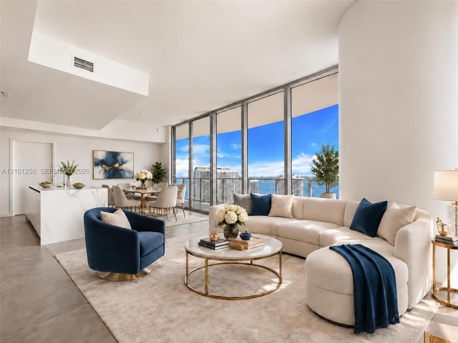 Open-concept floor plan featuring floor-to-ceiling windows, a stone-surfaced kitchen island, and a balcony with water scenery