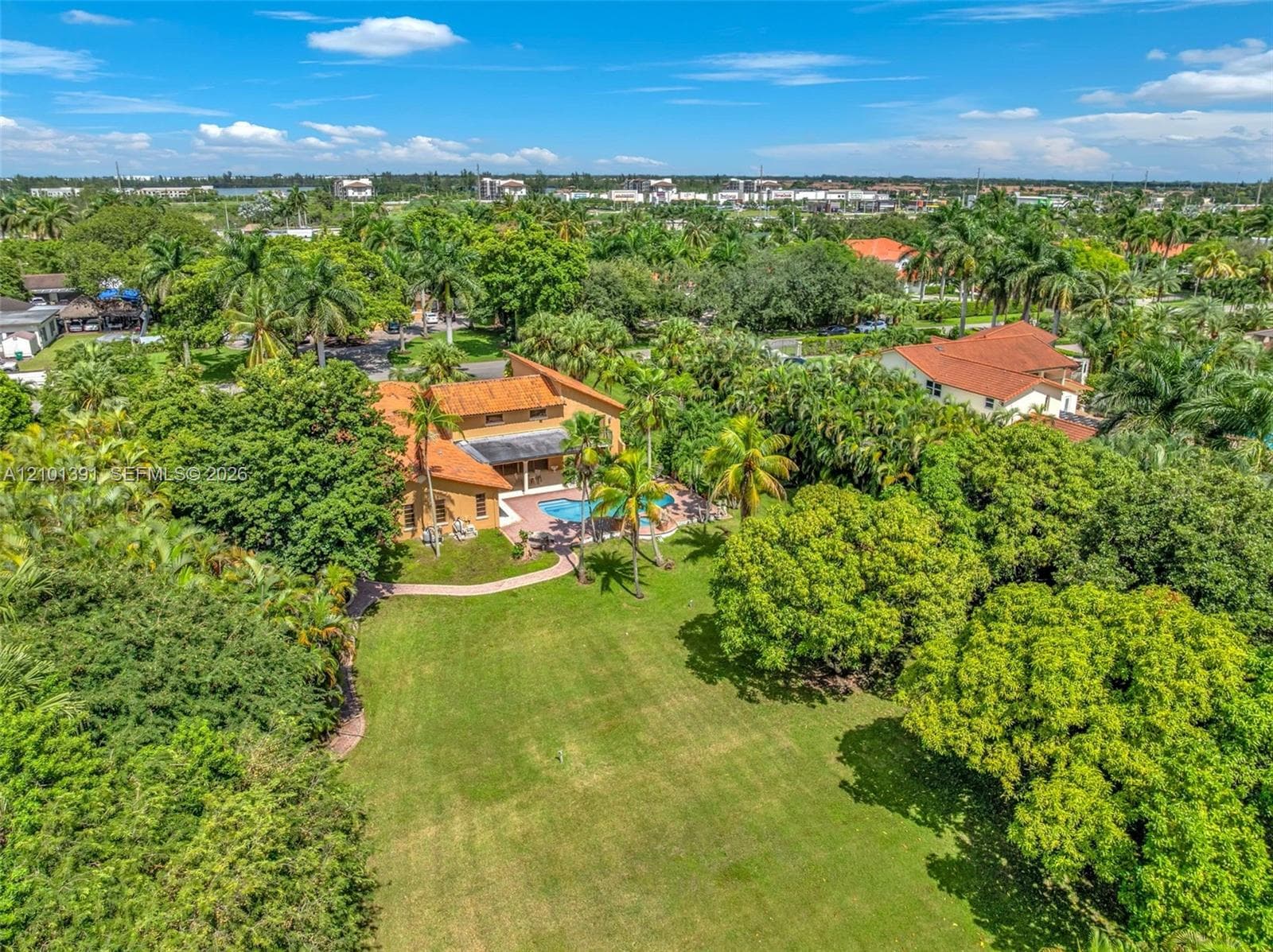 Expansive property featuring a large lawn, a private swimming pool, and a terracotta tile roof