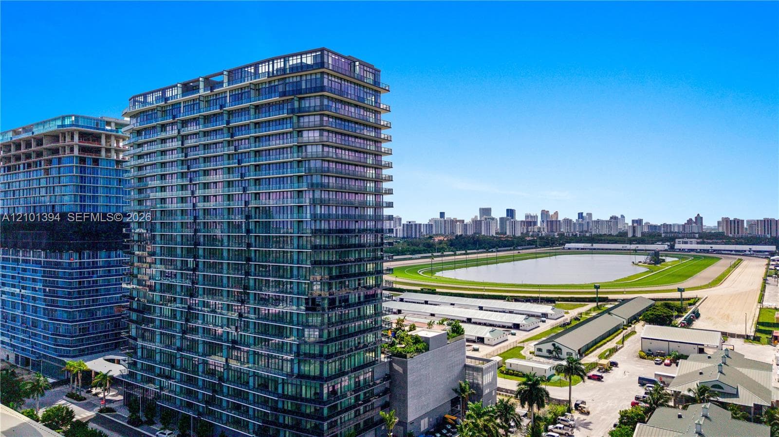 High-rise exterior featuring floor-to-ceiling glass windows, private balconies, and concrete and glass facade construction