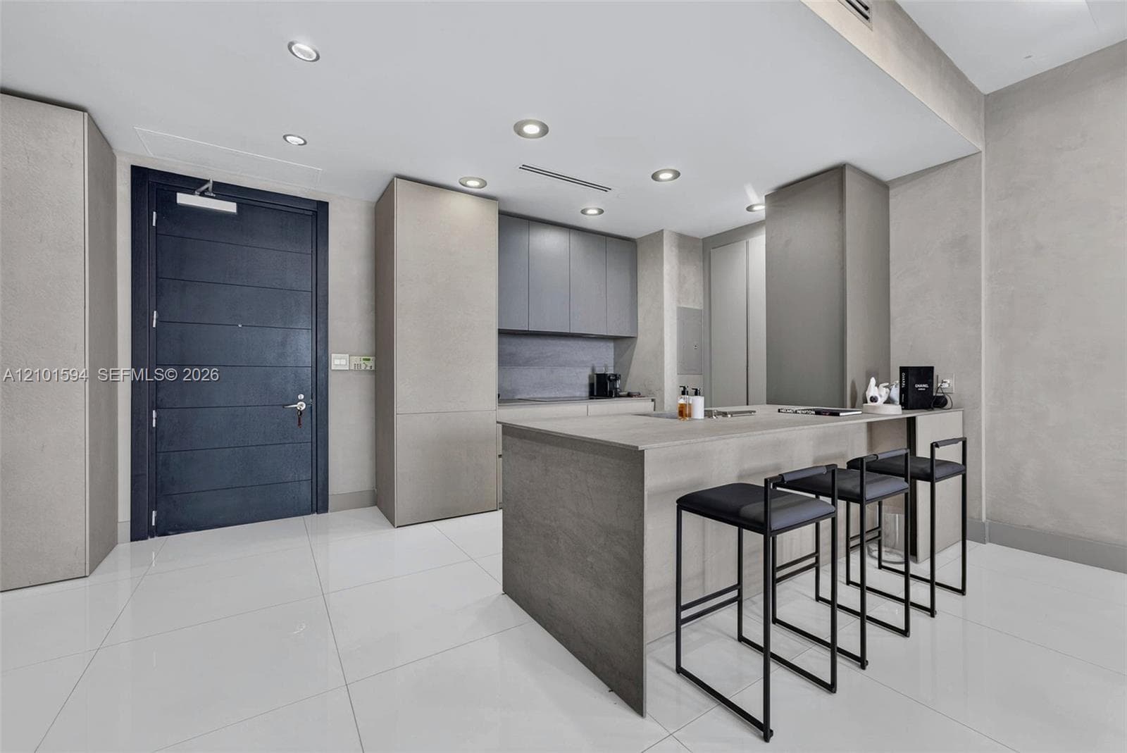Kitchen island with seating and direct connection to the main living area.