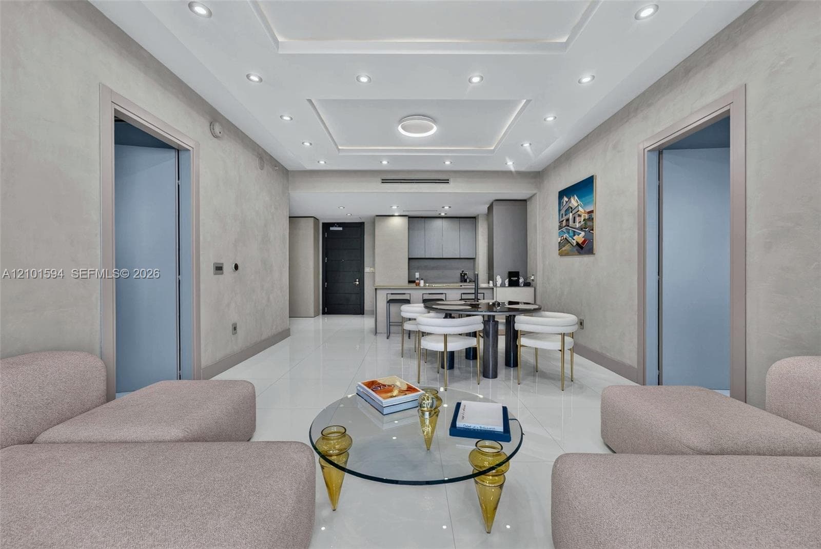 Living room open to the dining area and kitchen, with modern finishes.