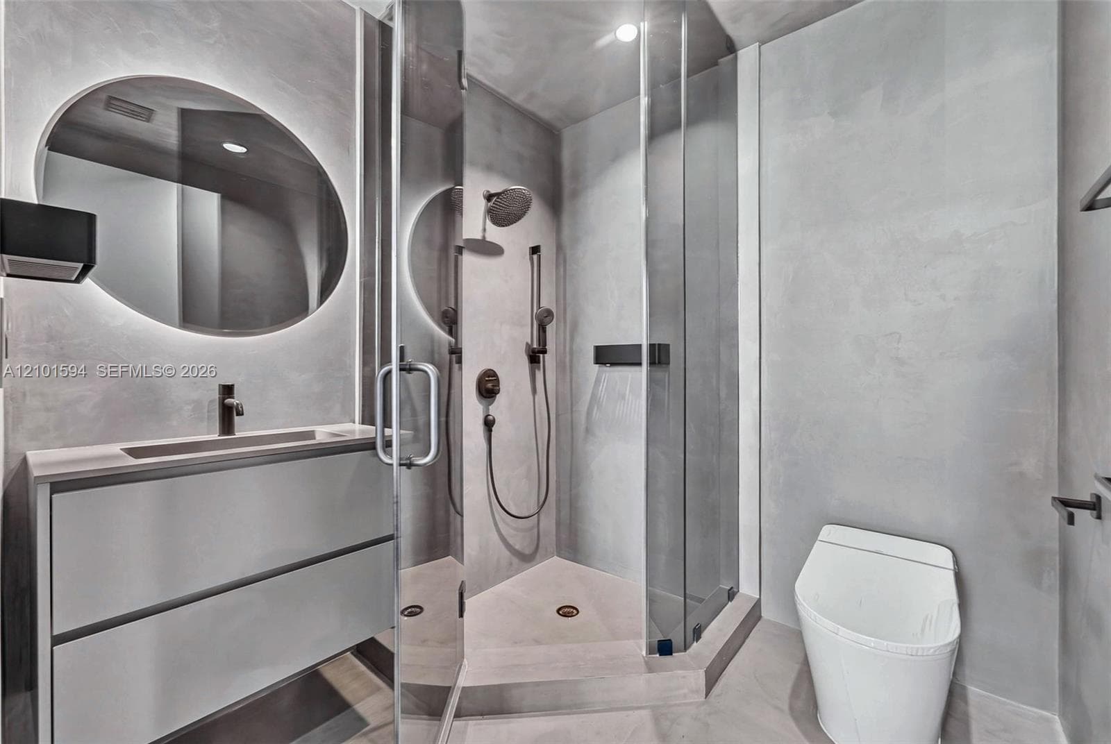 Full bathroom with glass-enclosed shower and contemporary vanity.