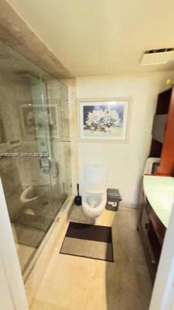 Walk-in shower with floor-to-ceiling natural stone tile, glass enclosure, polished metal fixtures, and built-in vanity with integrated basin