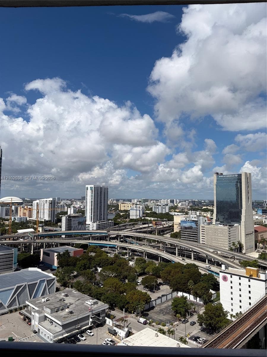 High-rise urban landscape featuring expansive city skyline, commercial high-rise buildings, and elevated roadway infrastructure