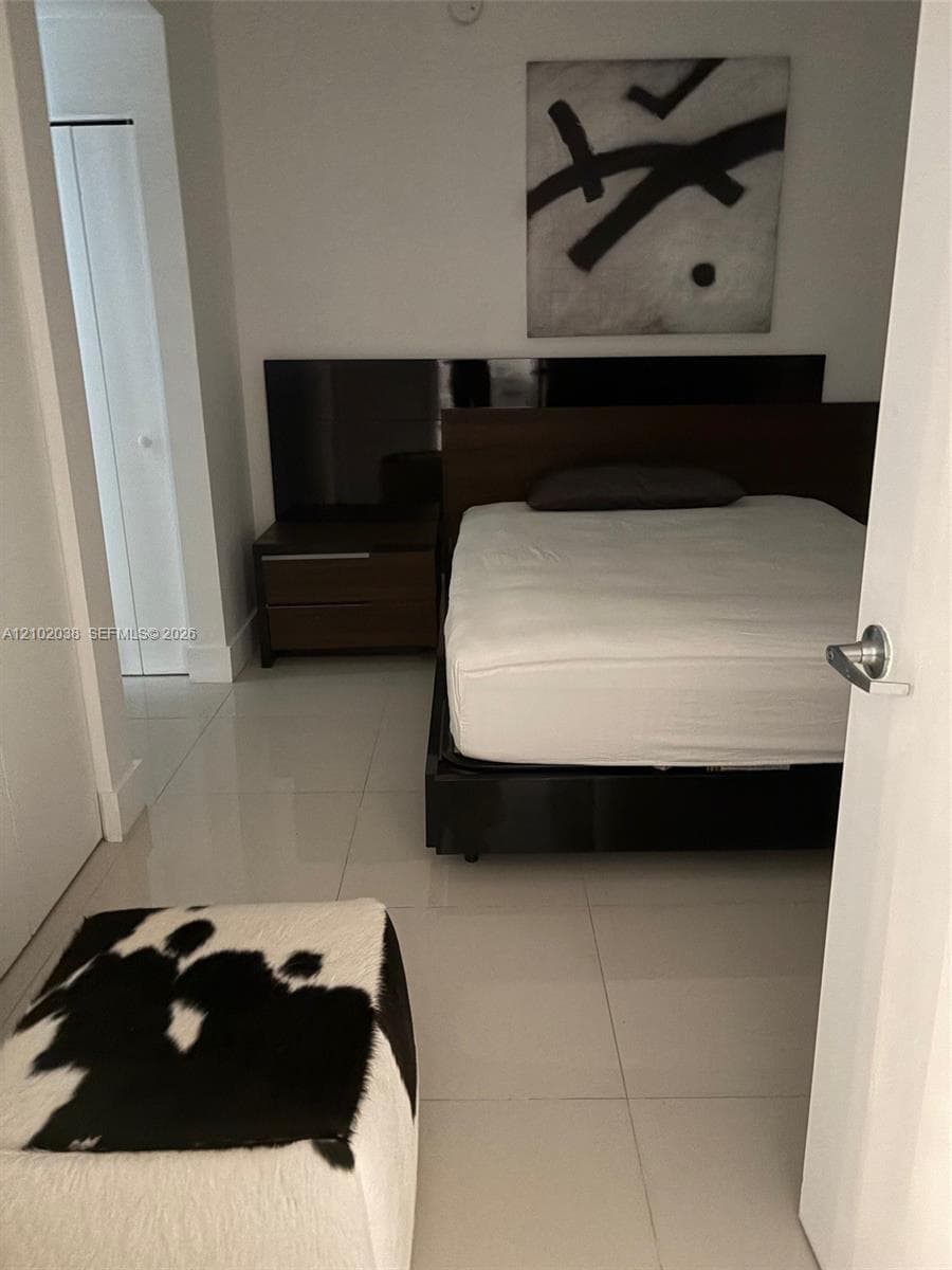 Large format tile flooring and white interior wall finishes