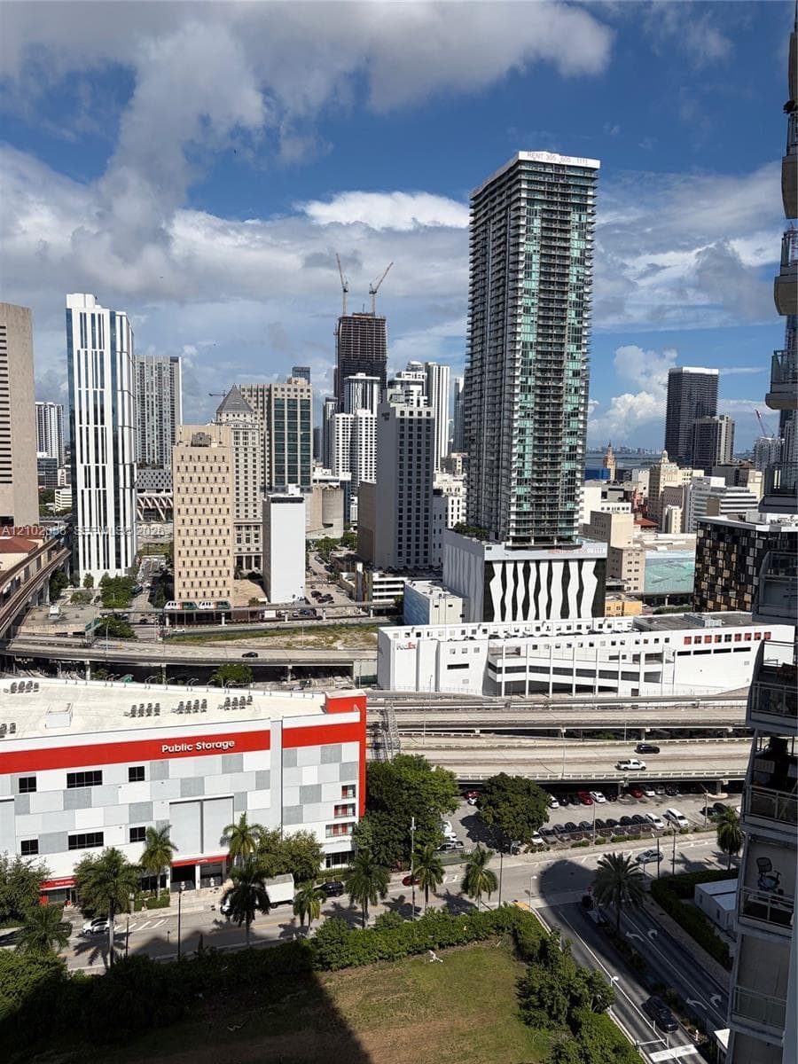 Panoramic urban landscape featuring high-rise architecture, metropolitan infrastructure, and palm-lined streets