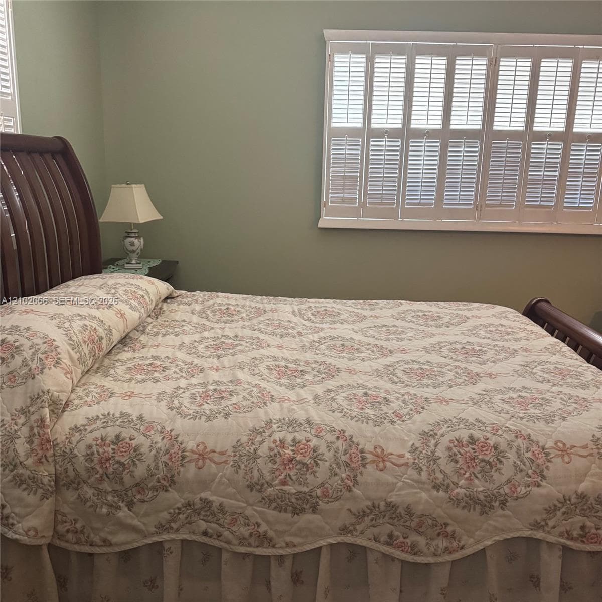 Interior space featuring white plantation shutters and neutral wall paint