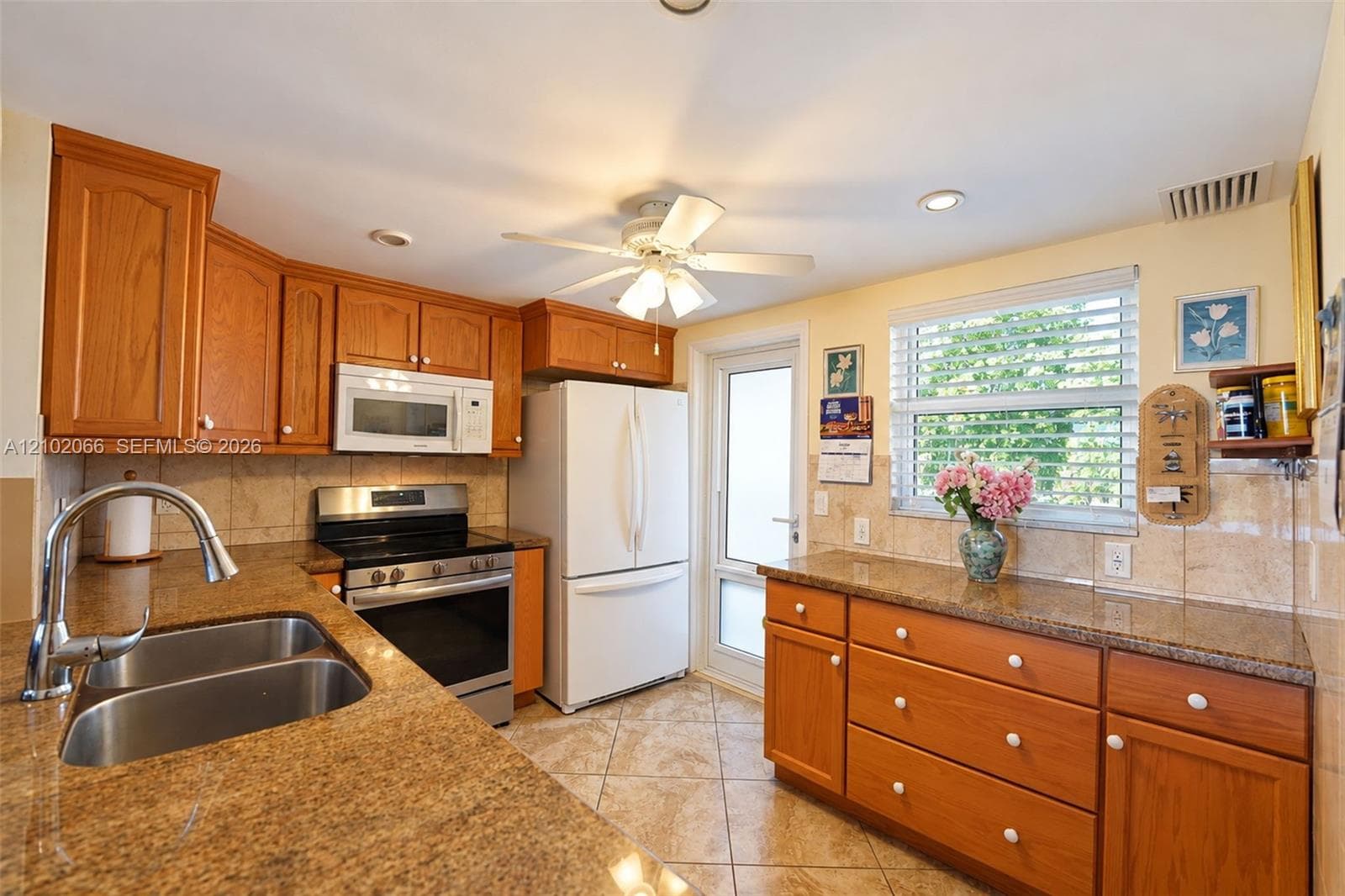 Room featuring neutral-toned walls, tile flooring, and a ceiling-mounted fan