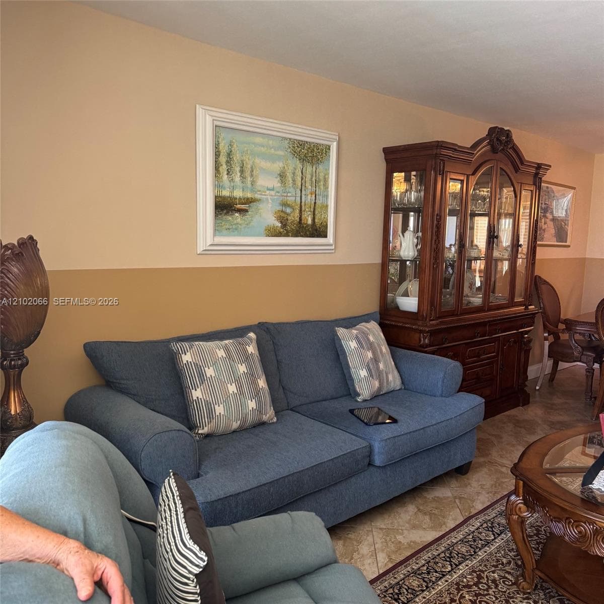 Two-toned painted walls featuring a horizontal color divide and light-colored tile flooring