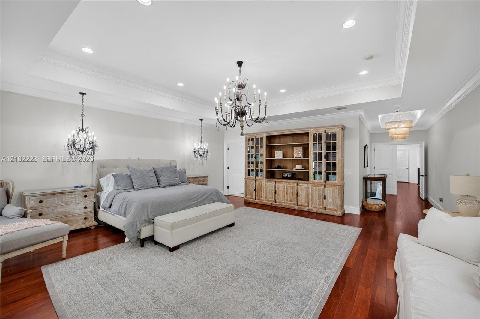 Another perspective of this extraordinary primary suite reveals its remarkable scale and versatility with room for a king size bed, a substantial sitting area and additional furnishings without compromising. It’s spaciousness. This is a true owners retreat where luxury is measured in both comfort and space.