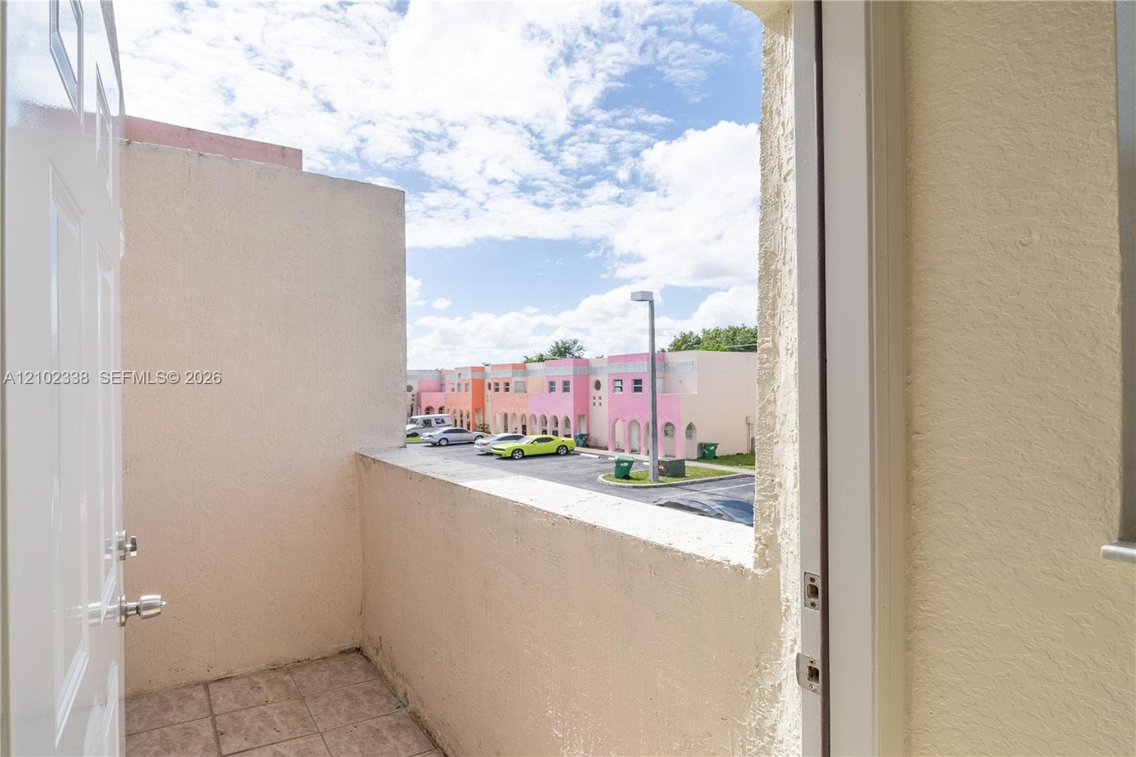 Balcony with tiled flooring and stucco walls