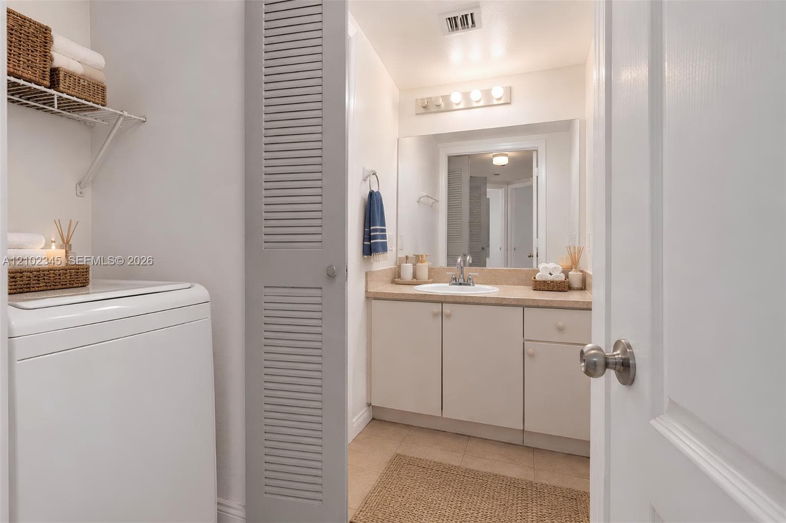 Bathroom vanity with an integrated sink, polished chrome faucet, and neutral countertop