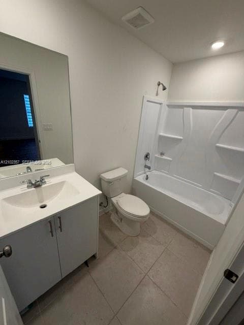Bathroom featuring a vanity with a solid-surface countertop, an integrated sink, a full-height wall mirror, a ceramic tile floor, and a tub-shower combination with a molded surround