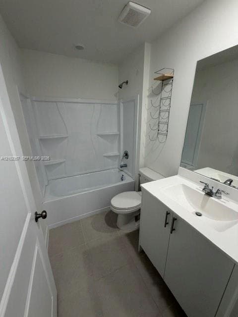 Bathroom featuring a white vanity cabinet with a stone countertop, integrated sink, large wall-mounted mirror, and a tub-shower combination with built-in shelving