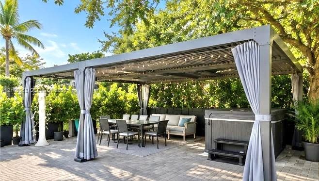 Outdoor pergola featuring a metal frame with slatted roofing, paver stone patio, and integrated spa