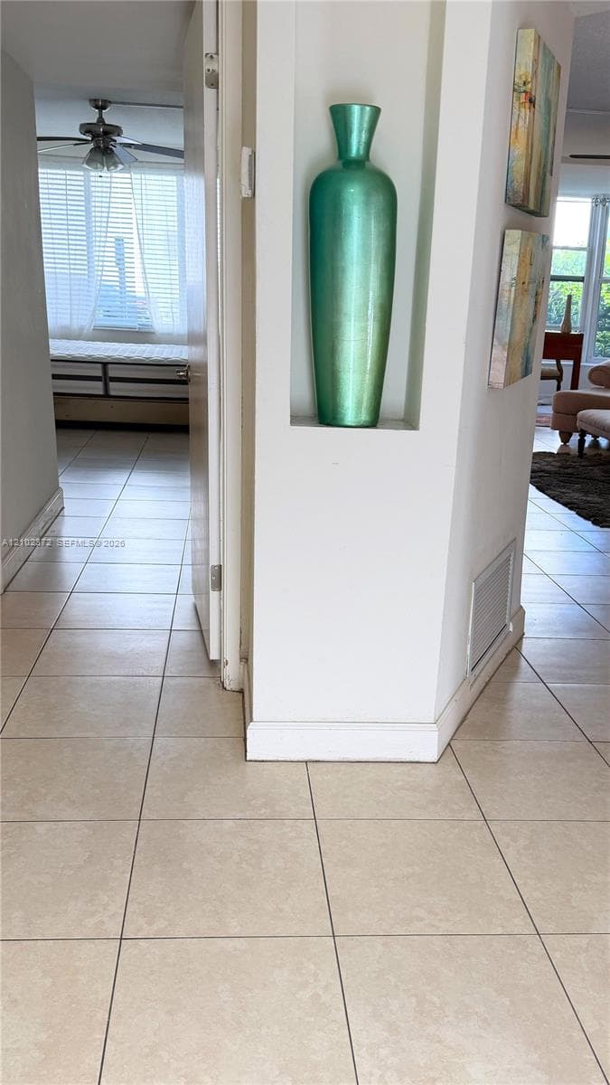Neutral tile flooring with square-cut layout and built-in recessed display niche