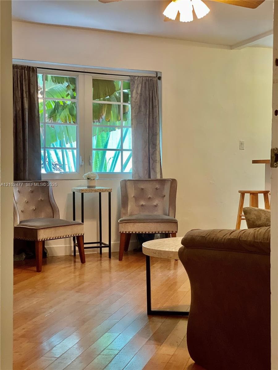 Wood-finish flooring, multi-pane casement window, and overhead ceiling fan fixture