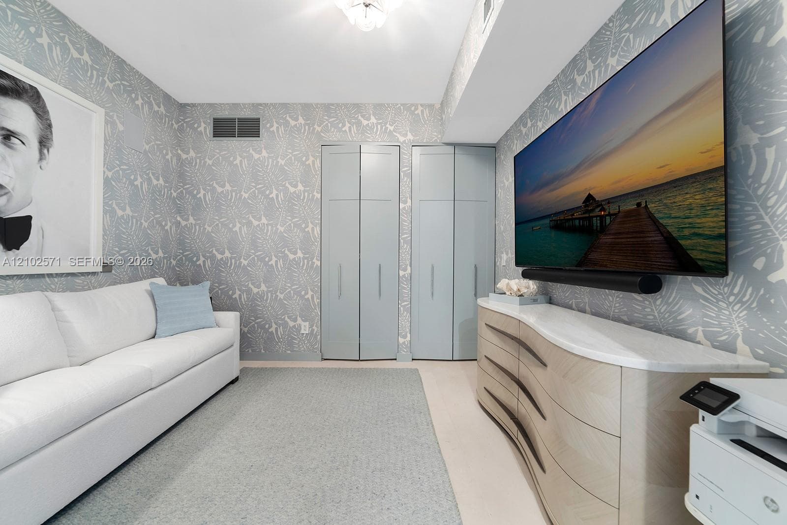 Room featuring patterned wallcoverings, dual floor-to-ceiling closets with flat-panel doors, and recessed ceiling lighting